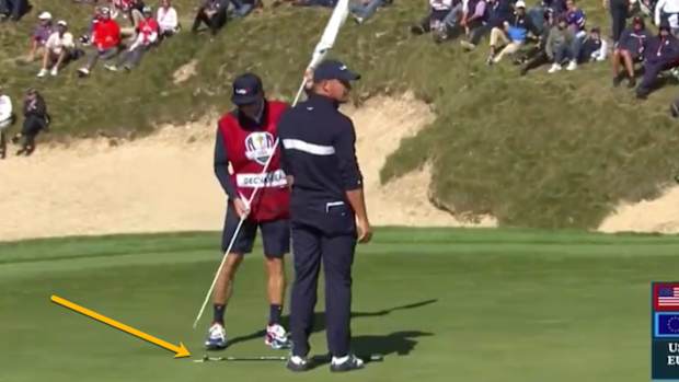 bryson-dechambeau-lays-down-putter